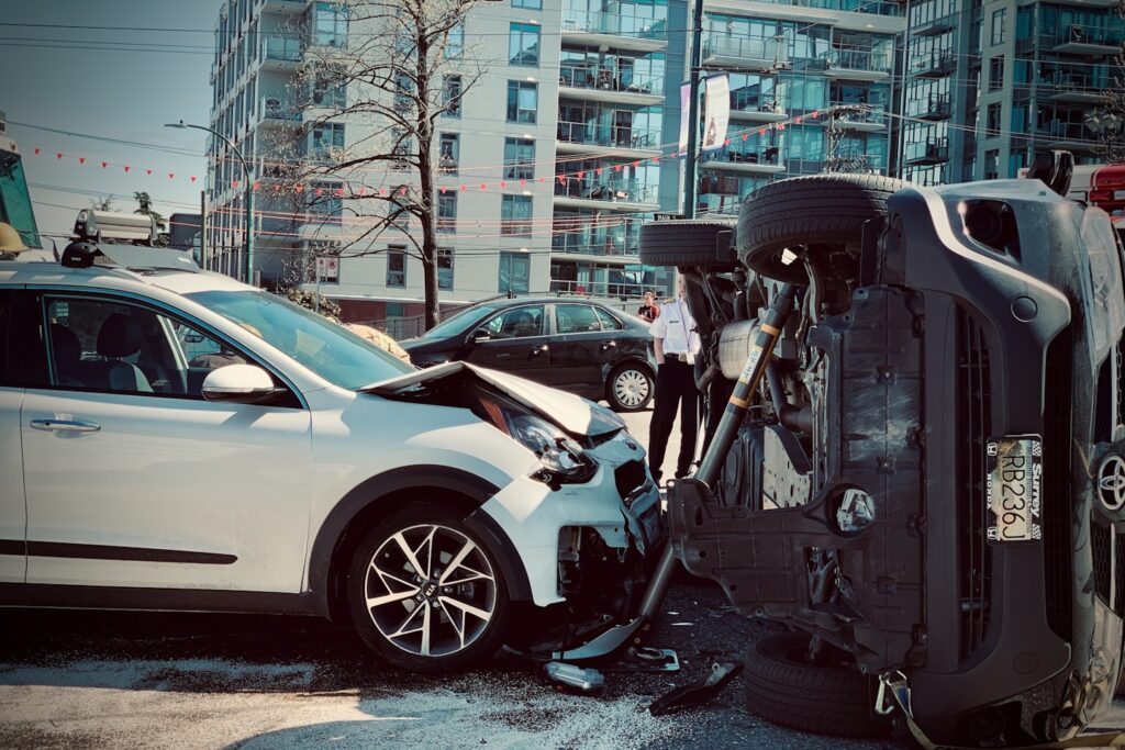 Rollover car crash automobile traffic accident broadside collision causing rollover with first responder firemen stabilization brace deployed.
